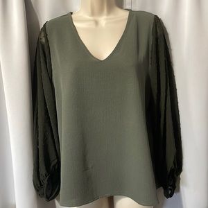 Cute V-neck pull over blouse with long sleeves gathered at wrist.